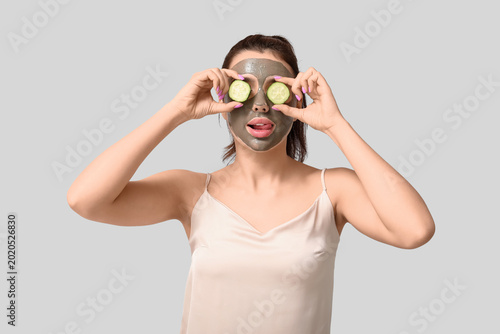 Young woman with facial mas...