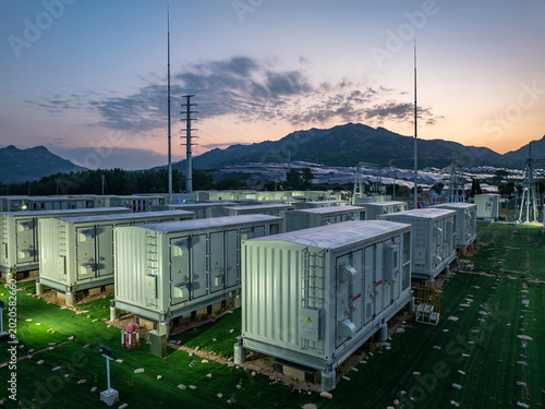 Schilderij op canvas Energy storage power station with containerized equipment arrays situated in mou