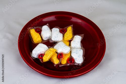 Loose dishwasher tablets isolated on a plate in the scullery