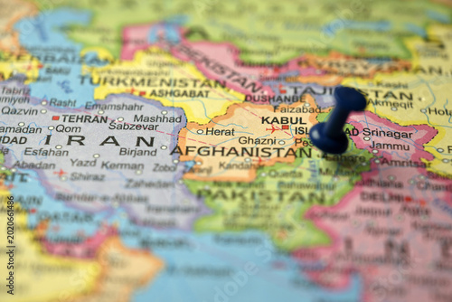Blue Push Pin Highlighting Afghanistan on Blurred World Map Macro Travel Background