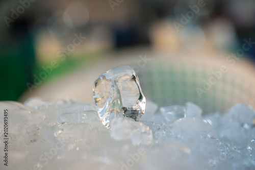 Fotografie Stacked blocks of clear ice with a single, distinct block resting on top