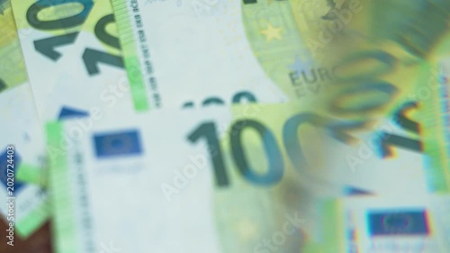 Blurred 100 euro bills shimmer through a prism