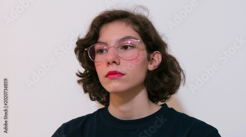 Self-expression of the trans model. Zoomer. Contemplating transwoman with vivid lipstick and fashionable makeup