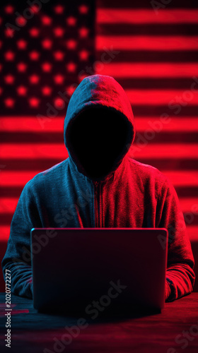 Cyber security hacker hooded figure laptop 4th july theme with glowing USA flag backdrop tense mood for data breach and online protection