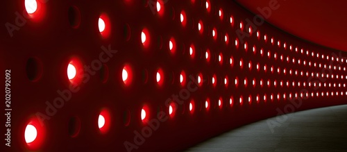 Modern curved wall with rows of bright red circular lights receding