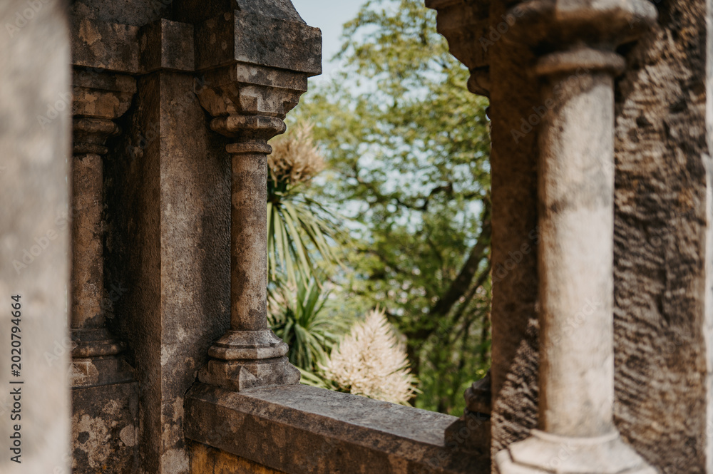 Fototapeta premium View through stone arches to garden at Pena Palace in Sintra