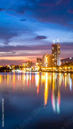 Blurred Cityscape Lights Reflecting on Lake Water at Night
