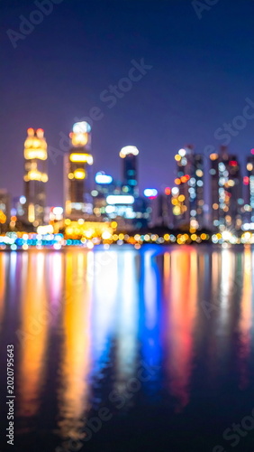 Blurred Cityscape Lights Reflecting on Lake Water at Night