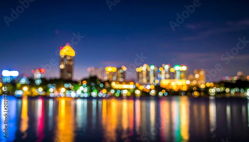 Blurred Cityscape Lights Reflecting on Lake Water at Night