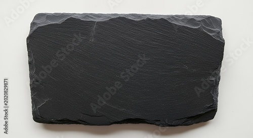 Empty rectangular black slate serving board with rough edges on a white background, top view.
