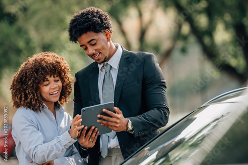 woman buying a car with a sales agent