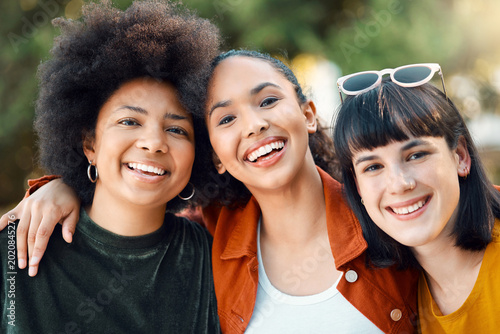 Women  friends and happy portrait with hug outdoor for bonding  connection and belonging. Female people  funny laugh and together with diversity  support and reunion in nature park for sisterhood