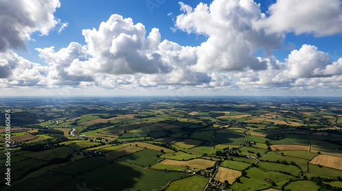 Aerial view of patchwork fields under cumulus clouds
