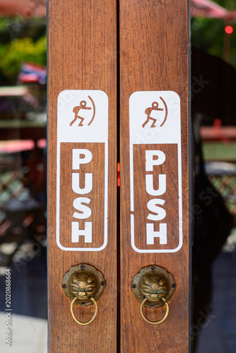 Push sign on wooden  doors in the coffee shop
