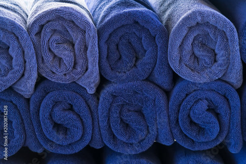 Rolled Towels: A collection of meticulously rolled blue towels, stacked neatly, portraying a sense of order and readiness for use.
