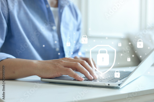 close up programmer man use laptop to log in private account in office for checking about confidential data with virtual symbol of cyber security system for future technology concept