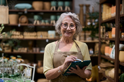 Senior woman small business owner checking inventory
