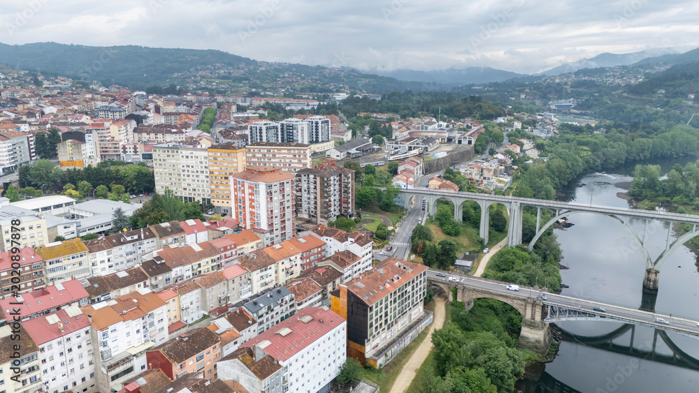 Fototapeta premium Ourense cityscape showing mino river with bridges