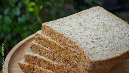 Canvastavla Whole wheat bread on wooden background