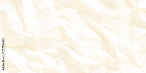 Fotografía Crumpled cream colored paper texture background with soft folds and creases