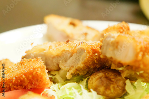 Close-up of crispy tonkatsu pork cutlet with juicy sliced meat and shredded cabbage