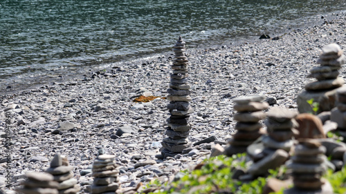 Photography Meditative Stone Stacks on a Serene Pebble Beach, Symbolizing Balance and Tranqu