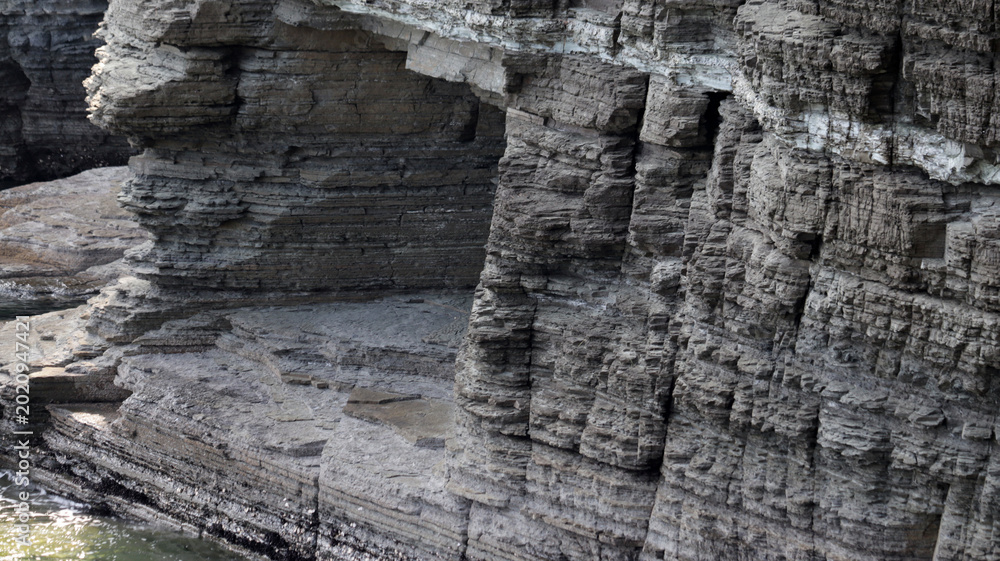 Fototapeta premium Ancient Layered Geological Formations: Prehistoric Landscape Reflecting Earth's Primeval Era and Potential for Dinosaur Footprints