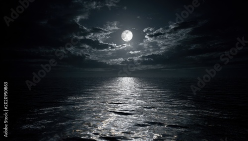 Mysterious Full Moon Reflecting on Dark Ocean Waves Under Cloudy Night Sky.