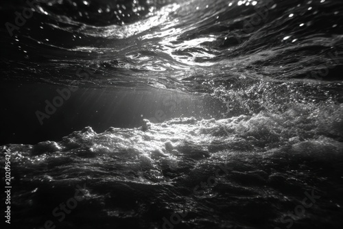 Underwater View of Sunlight Breaking Through Rippling Water Surface.