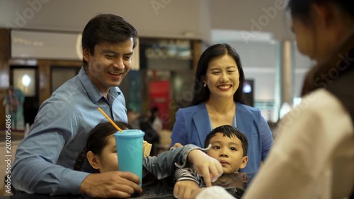 Family is go to watch movie at cinema complex during weekend. Lifestyle, weekend activity.