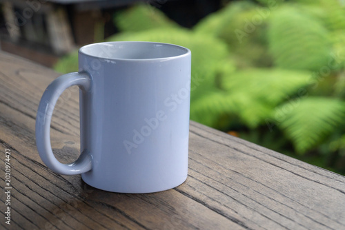 White Ceramic Mug On Wooden Table Outdoors Evoking Morning Coffee And Rustic Calm