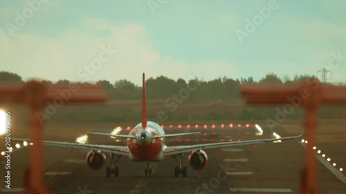 Airliner taking off with runway alignment shifted by strong wind. Jet accelerating and lifting off under crosswind causing visible displacement. Aircraft departing in windy conditions with drifted