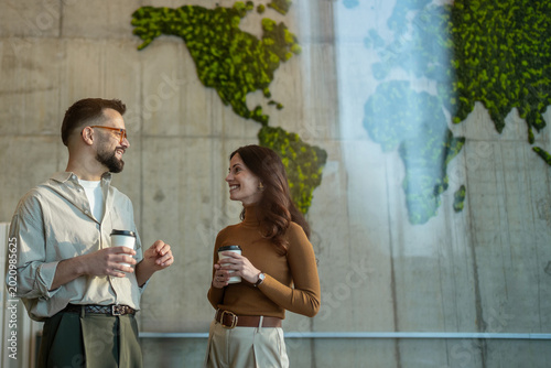 Fotografie Colleagues having coffee break discussing global business strategy