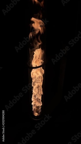 Large Flame Dancing Inside Vertical Glass Chimney Dark Background Footage