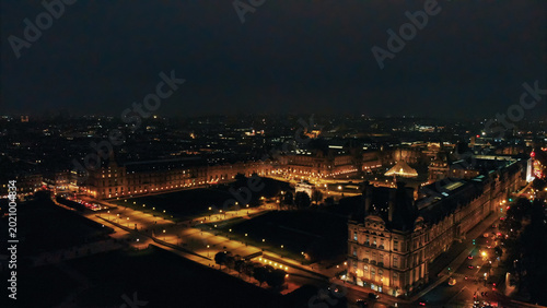Photography Louvre museum and tuileries garden at night, aerial view paris