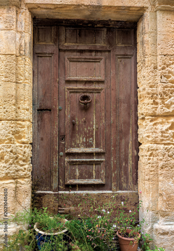 Fototapeta premium Old wooden door in stone frame in southern France