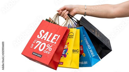 Hand holding colorful shopping bags with sale discounts and online shopping promotions