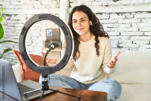Woman recording video for social media content, interacting with her audience