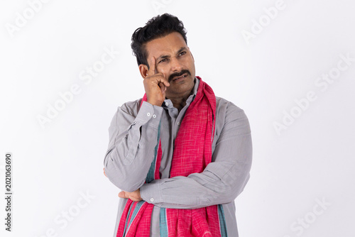 Obraz na plátne Portrait of a young indian deep thinking sad and discouraged farmer man lost dee
