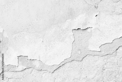 White background  of peeling white paint on an aged concrete wall, showing fl...