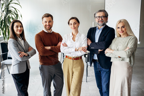 Fotografía Group of confident professionals from different generations posing with crossed