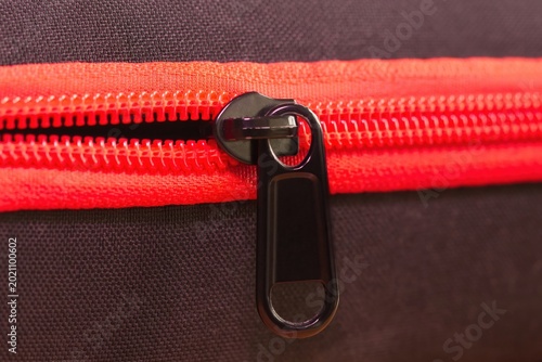 The red zipper on the bag.