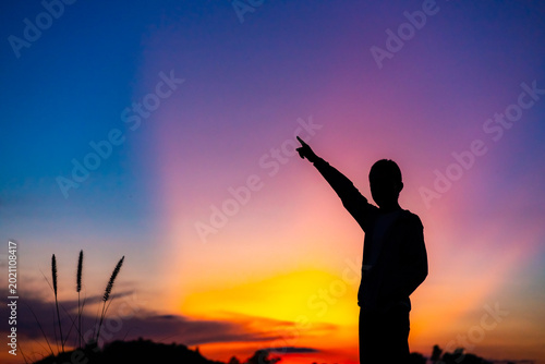 A silhouette image against the backdrop of an evening sky during sunset.