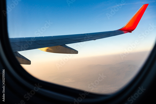 sunrise with Wing of an airplane. Photo applied to tourism operators or backdrop. picture for add text message or frame website. Traveling concept
