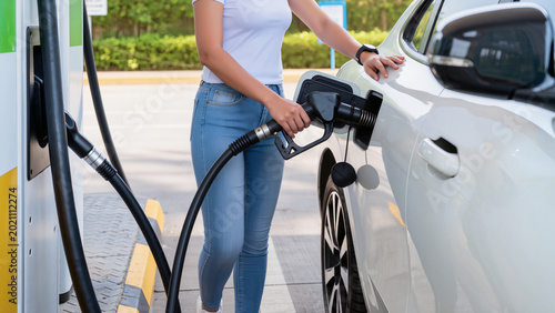 Tableau sur toile filling the car,
White sedan refueling at gas station
