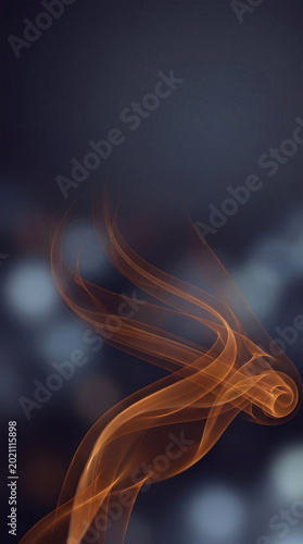 Abstract orange smoke swirl on dark background