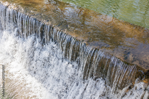 Photography Nabão River water flowing over weir in Tomar