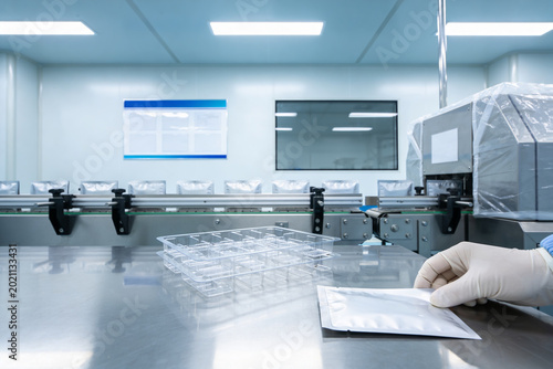 Canvas Print Cleanroom production line with sterile packaging and gloved hand holding a pouch