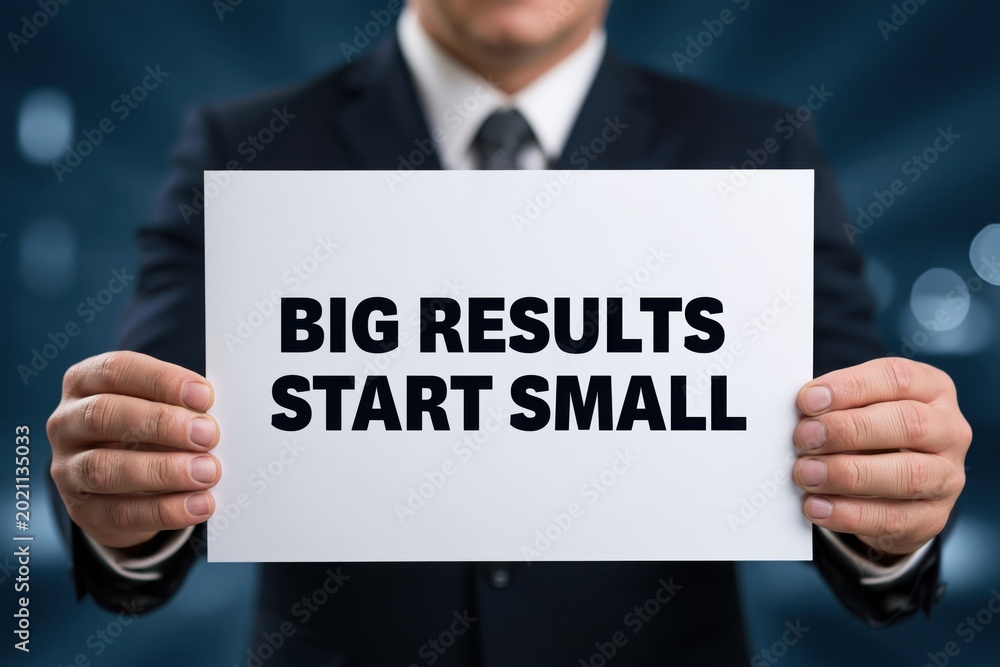 Fototapeta premium Entrepreneur with Sign: Big Results Start Small