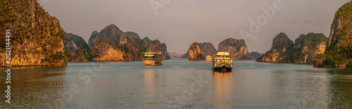 Konstfotografi A panorama view of cruise ships in the glow of the setting sun in Ha Long Bay, V